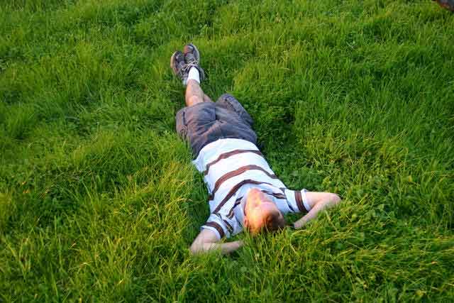 man lying in the grass
